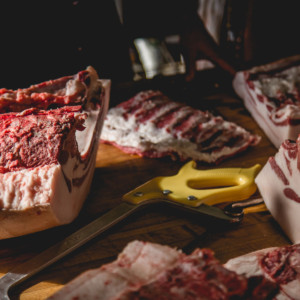 Butcher cuts on the table with saw